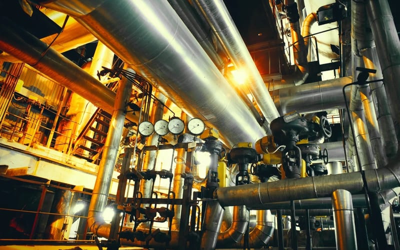 Engine oil cans, drums and grease containers in a clean warehouse
